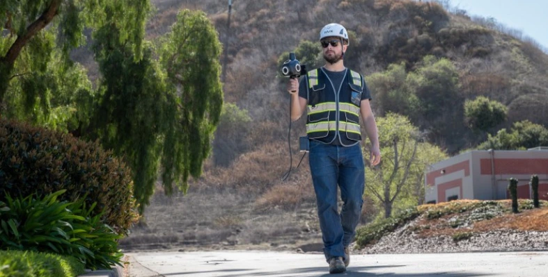 The Looq Platform produces survey-grade, georeferenced, ground-classified point clouds and orthomosaic images. (Image source: Looq AI) a_man_with_ppe