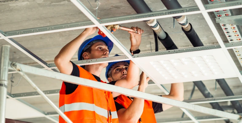 The report forecasts that the Saudi FM market will expand from US$39.4bn in 2024 to US$52.5bn by 2029 Two_men_wearing_hard_hats_inspecting_building_form